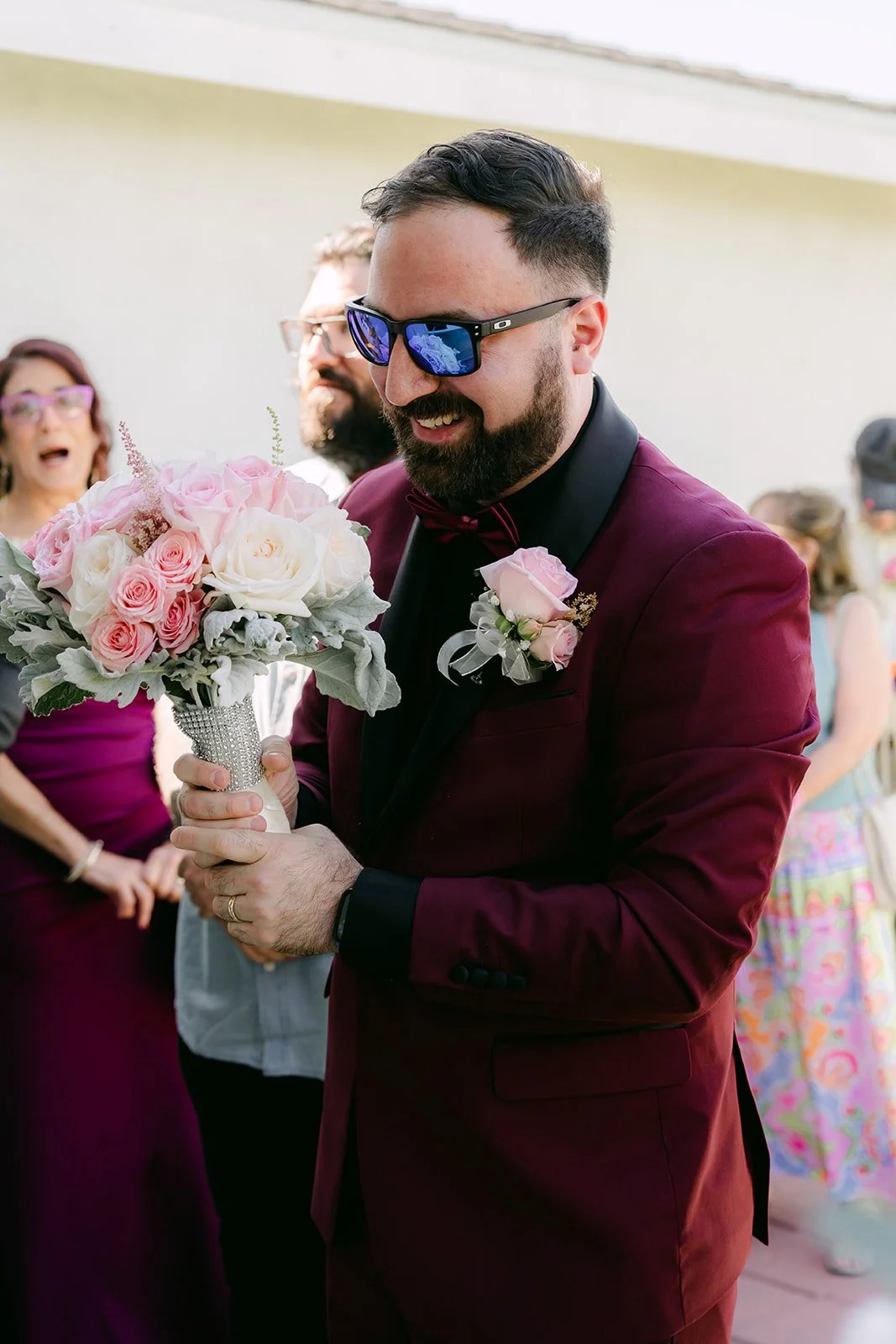 Ryan holding the bouquet as the door games begin.