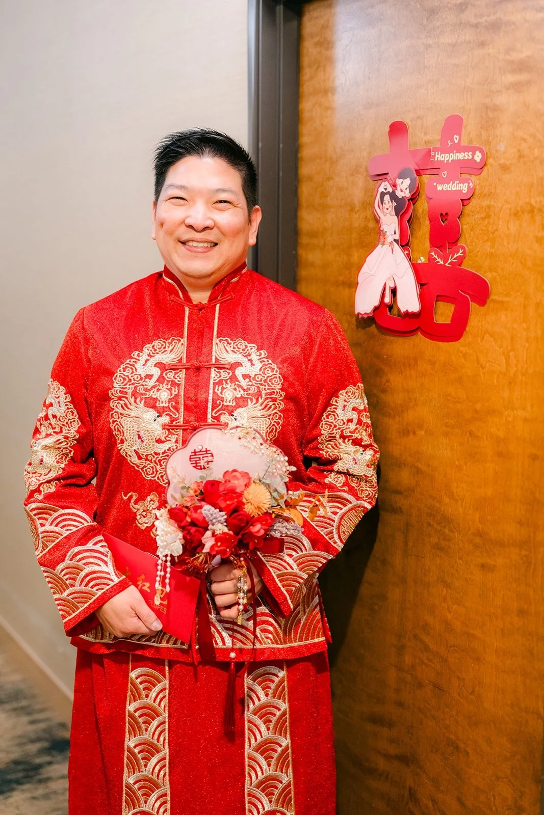 Jay in a red and gold embroidered jacket waits outside the door for the door game