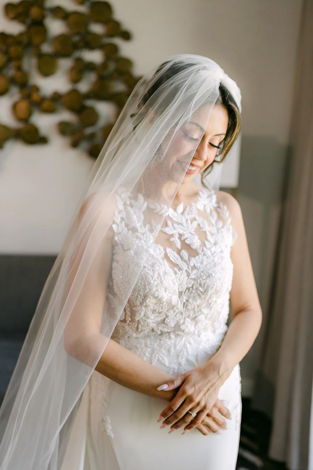 Francesca looks down at her hands under her lace veil