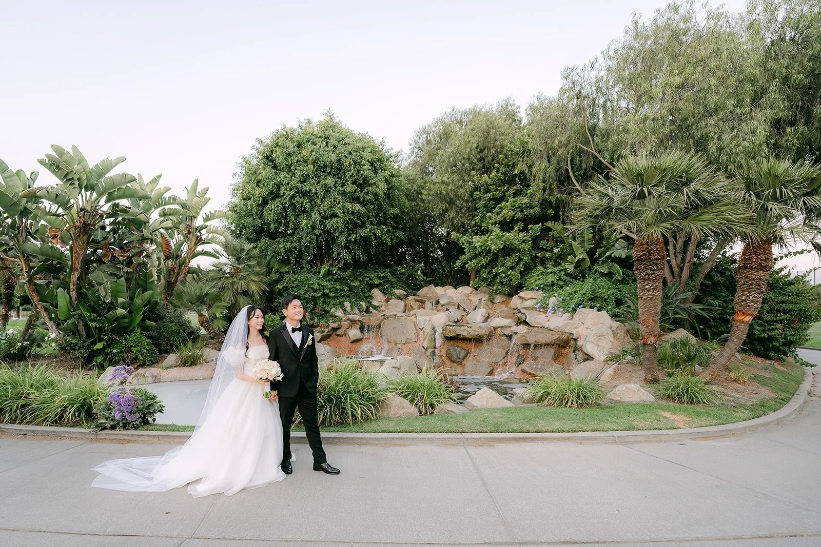 Jeannie and Eunsang in front of the rock waterfall at Skylinks Golf Course