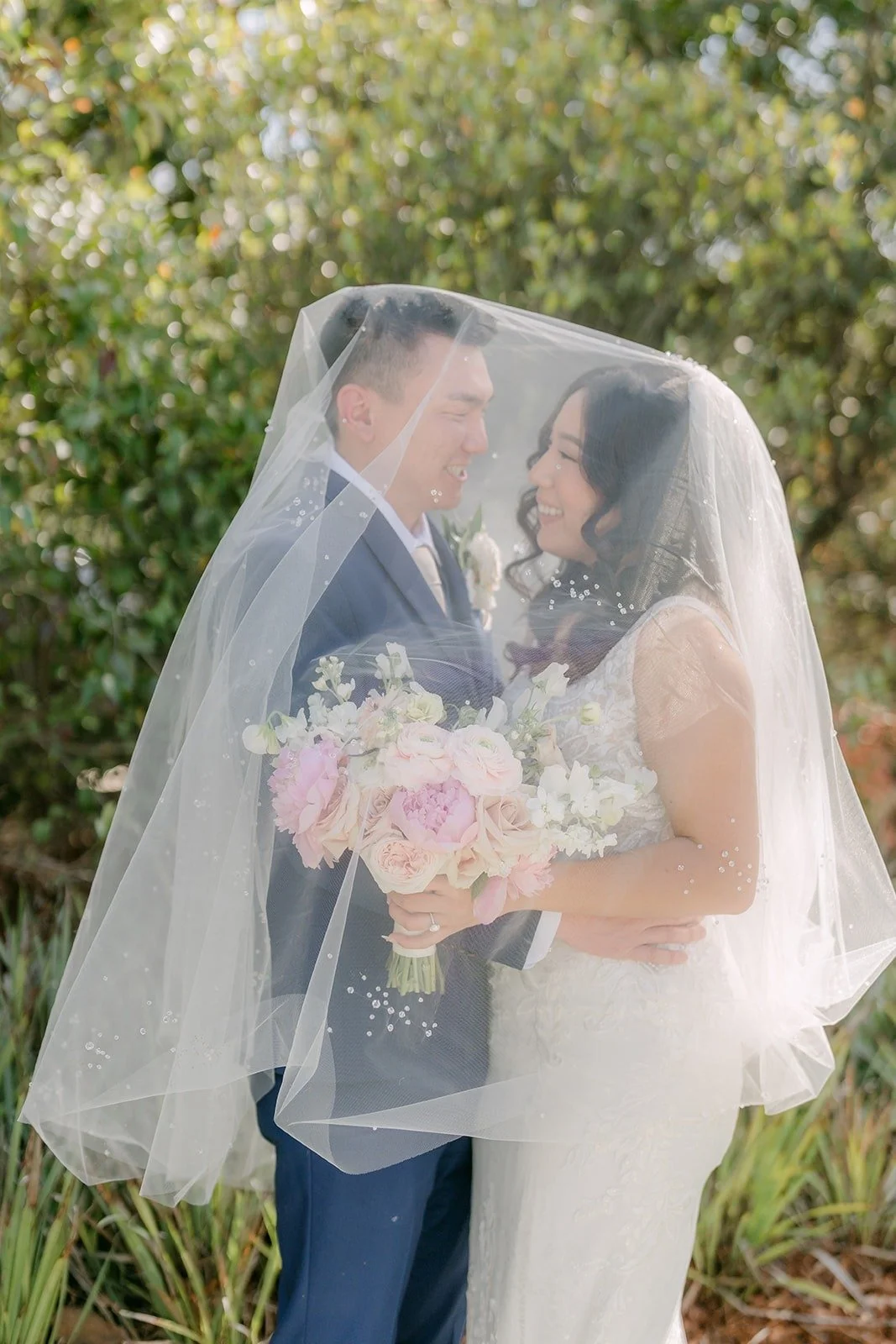 Kelli and Alex sharing a quiet moment under her veil