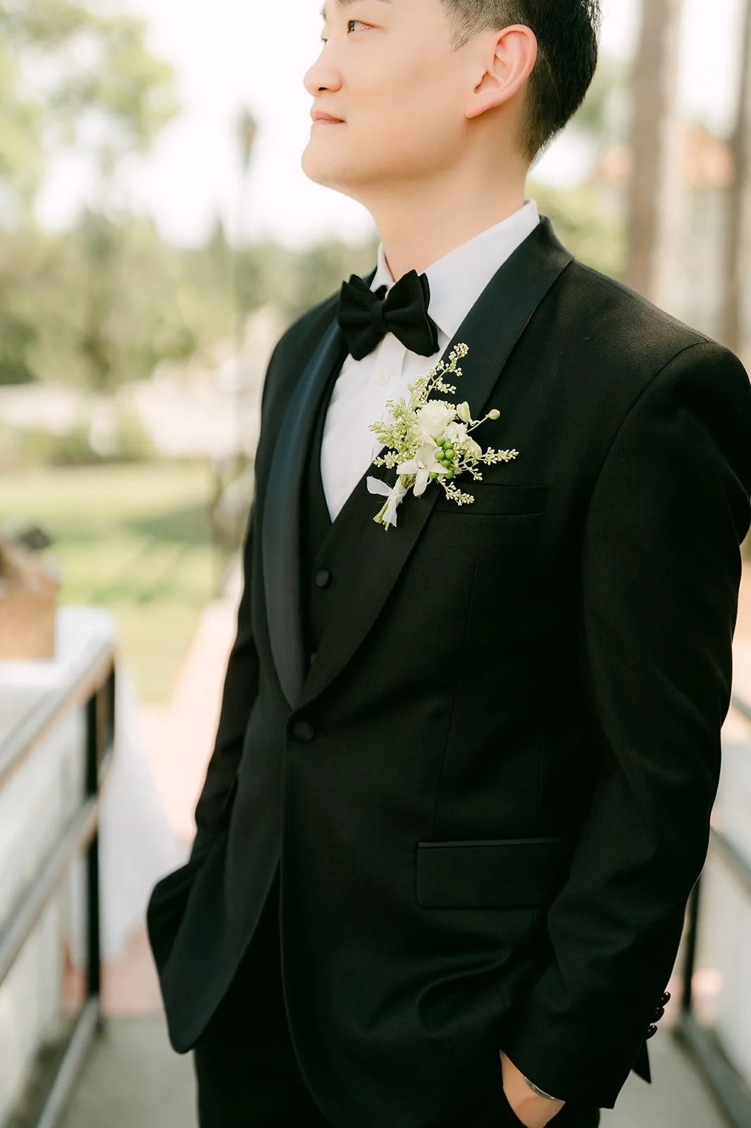 Sam with a white boutonniere, photographed by One and Only Production
