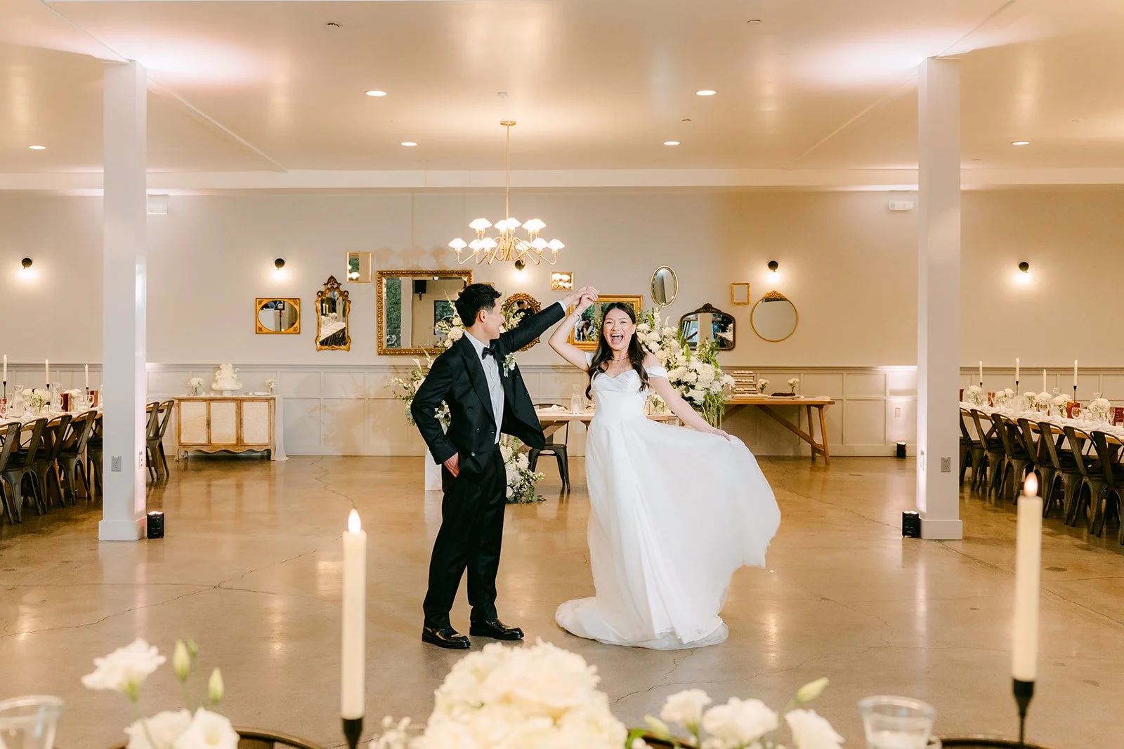 Richard twirling Jadee in the reception room