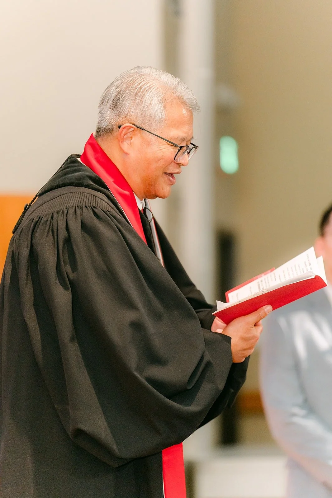Pastor Alan Chan reads during the ceremony