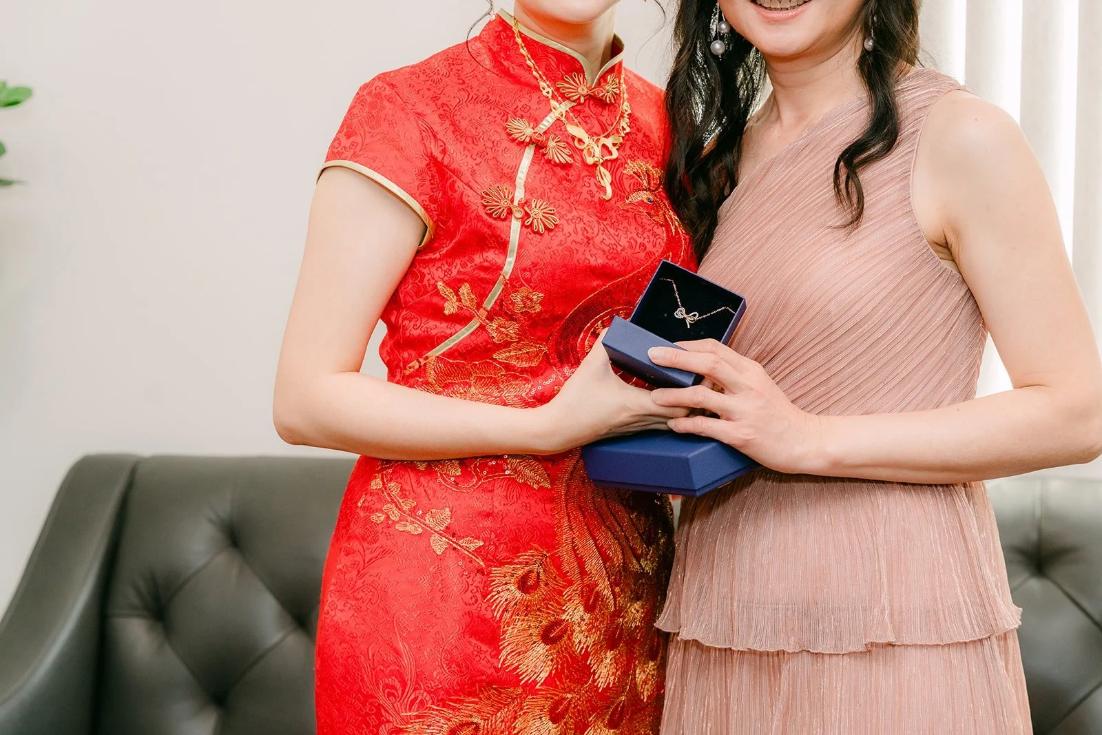 Eunice holds a blue jewelry box as a thank you gift for a bridesmaid