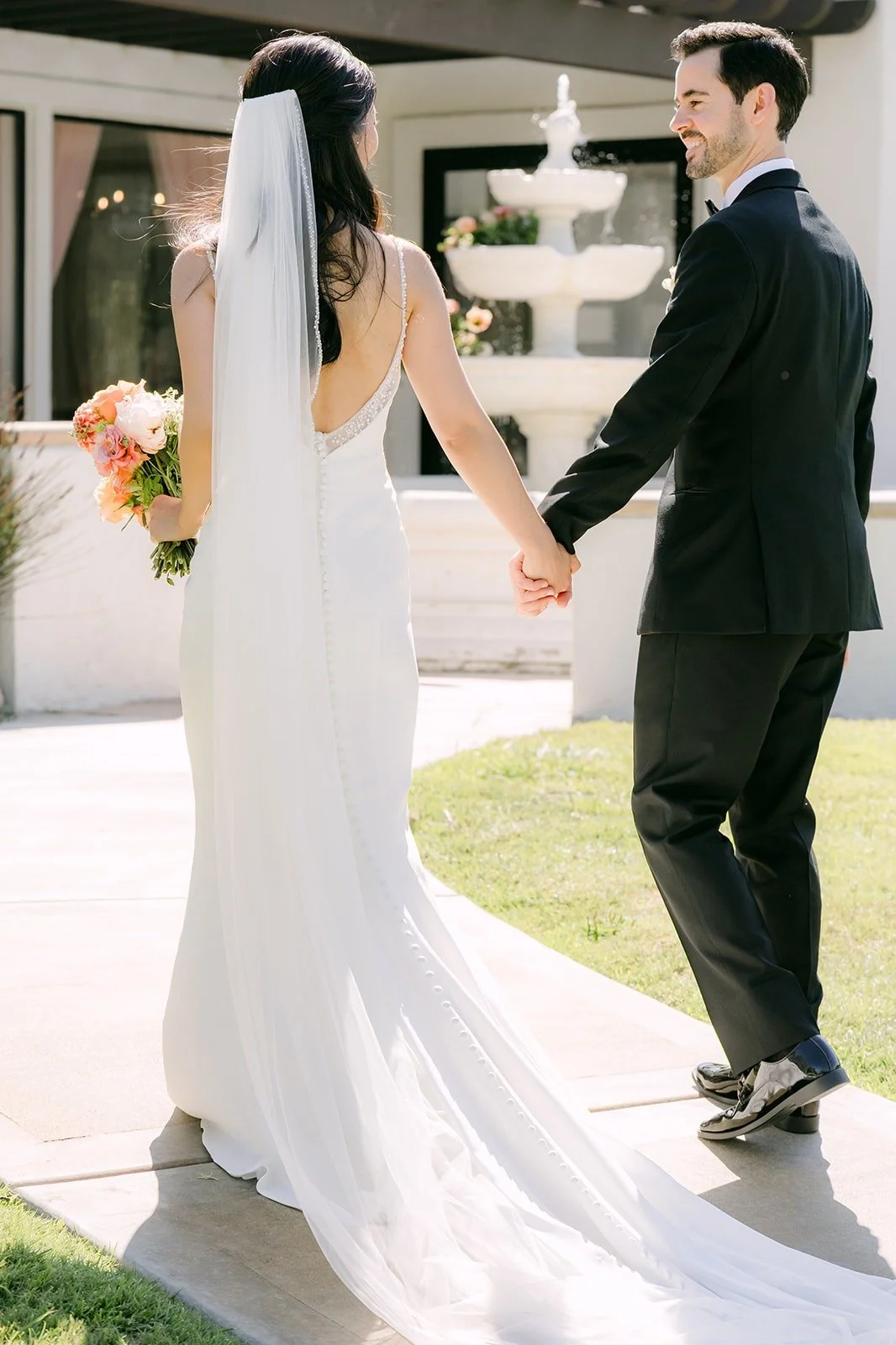 Stephanie leading Kevin by the hand down the walkway, photographed by One and Only Production