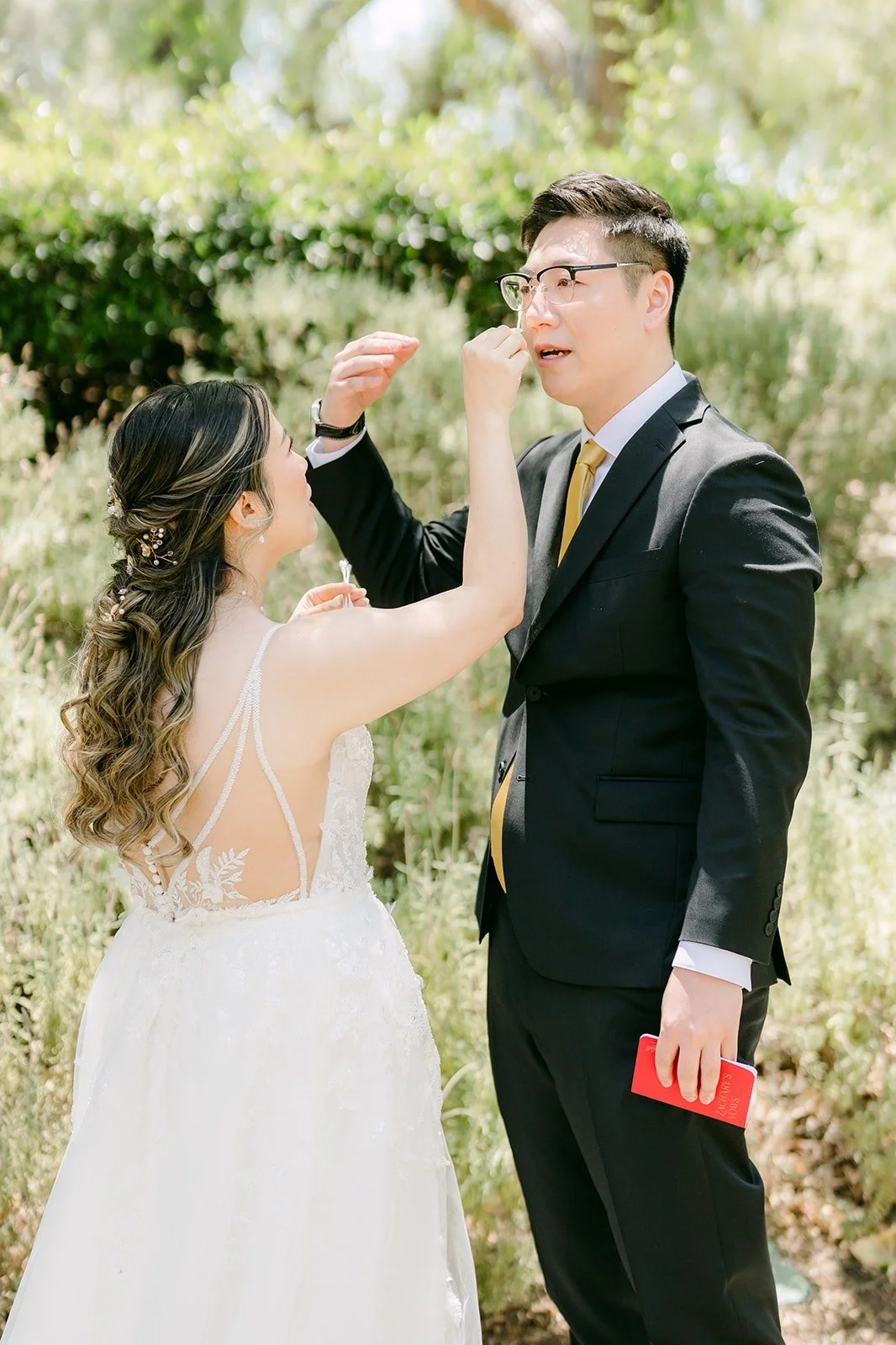 Zach wiping his eyes during their private vows, photographed by One and Only Production