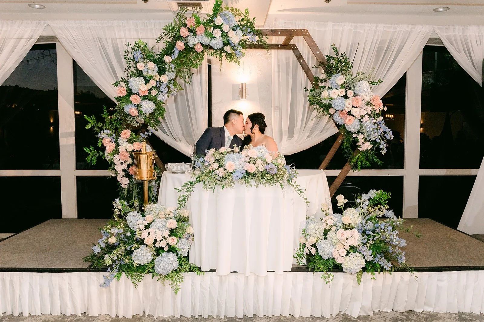 Sweetheart table with draping and florals in the Mediterranean Ballroom