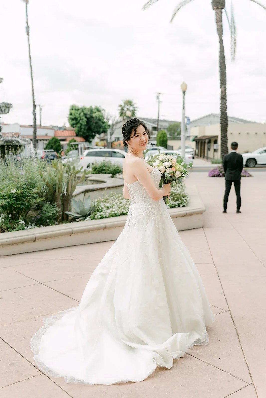 Eunice walks across the plaza toward Eric for their first look