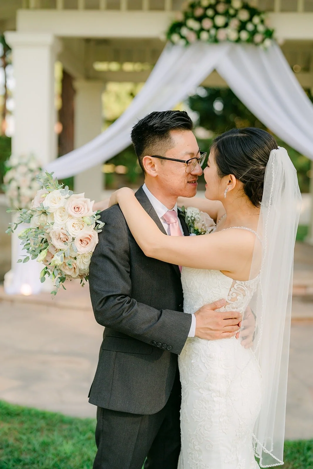Xuemin and Alex close together under the gazebo draping