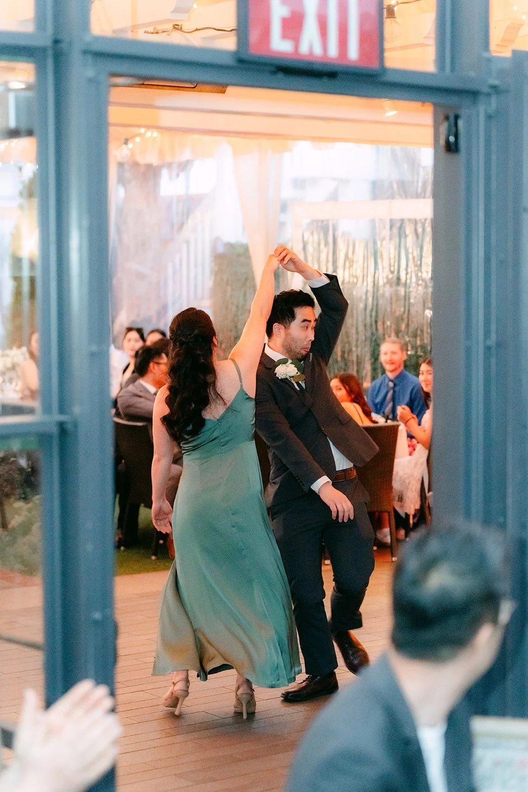 A bridesmaid and groomsman dancing into the reception