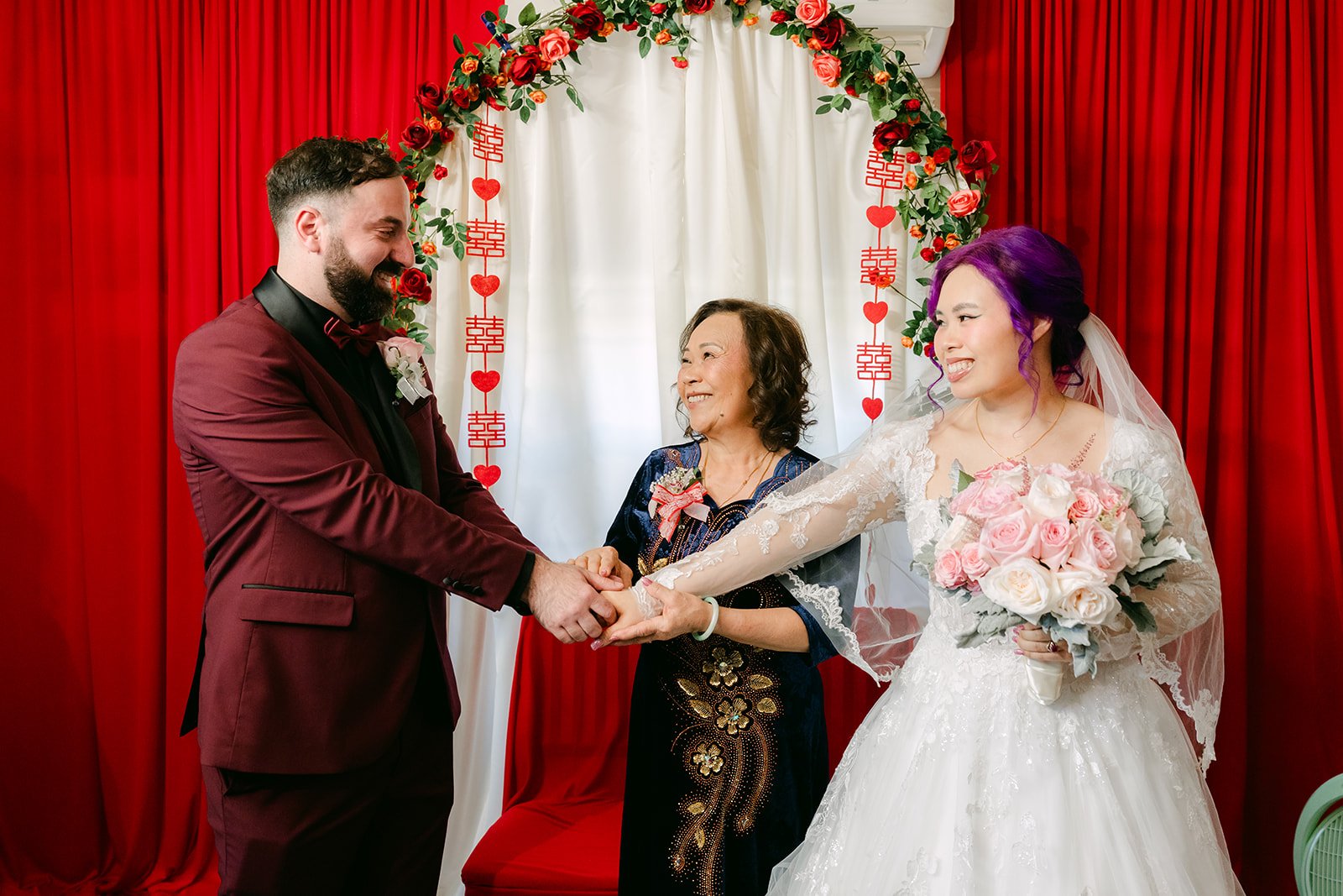 Vanessa's mom joining Vanessa and Ryan's hands, photographed by One and Only Production.