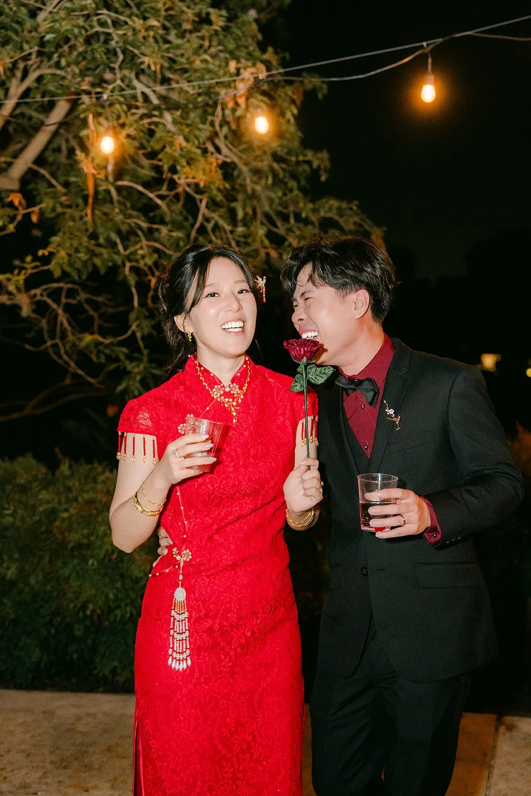 Elaine and Wen with drinks in hand at night.