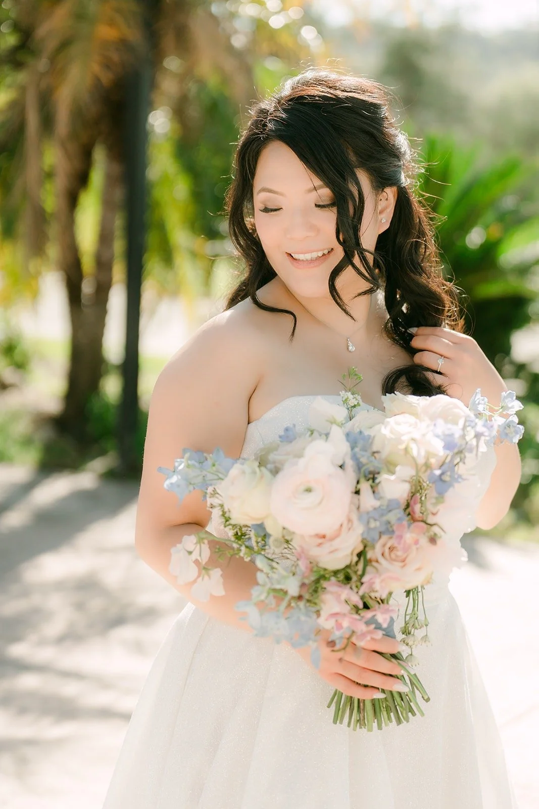 Florence holding her bouquet of blush roses and blue hydrangea