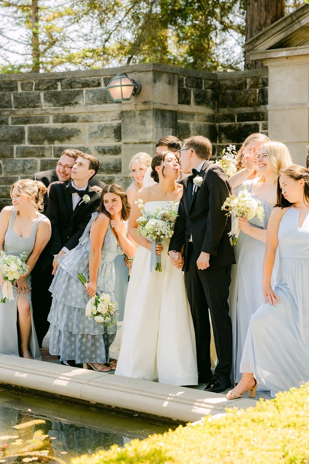 Wedding party laughing together in the courtyard