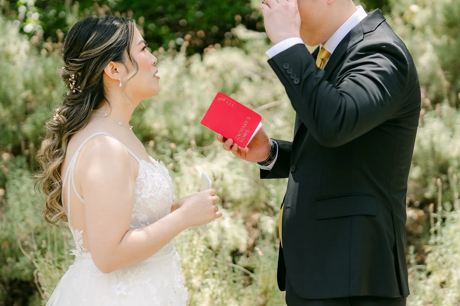 Joanne reading her private vows from a red vow book