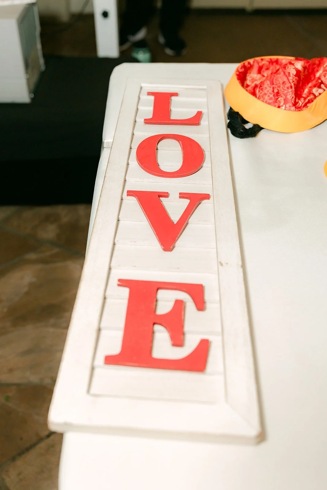 A red LOVE sign on the guest table