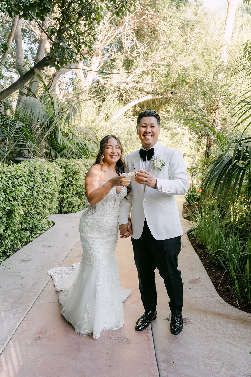 Nicole and Caryl celebrating at the end of the aisle, photographed by One and Only Production.