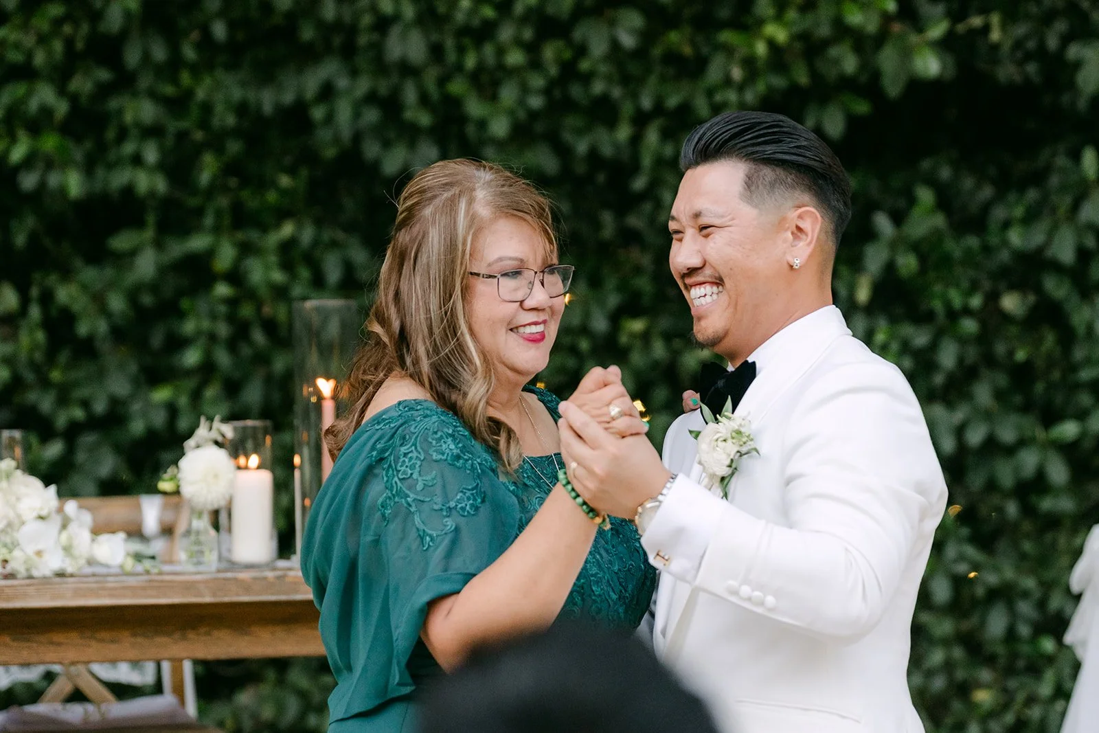 Caryl laughing with his mom during their dance, photographed by One and Only Production.
