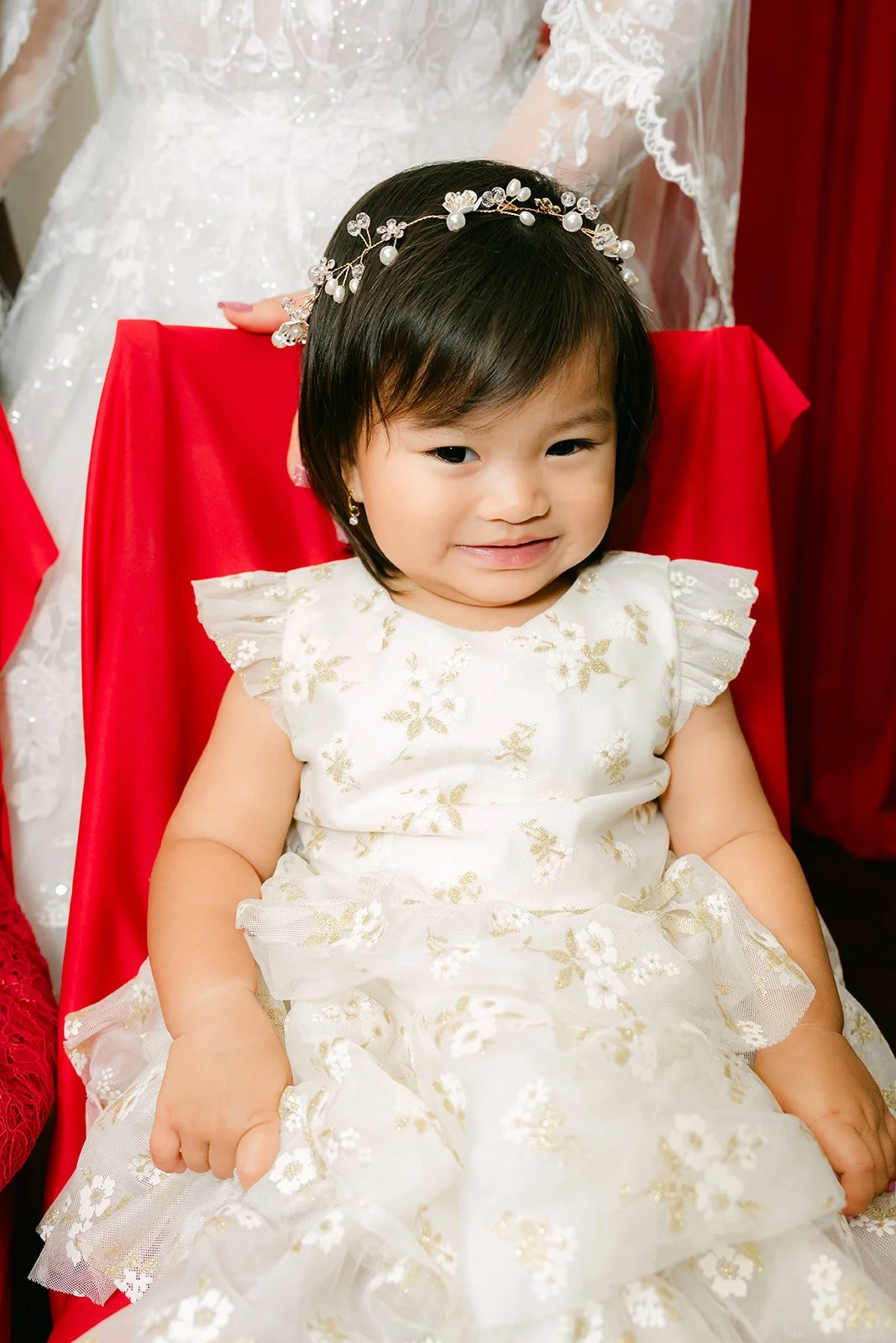 Vanessa's niece in a white dress and flower crown.