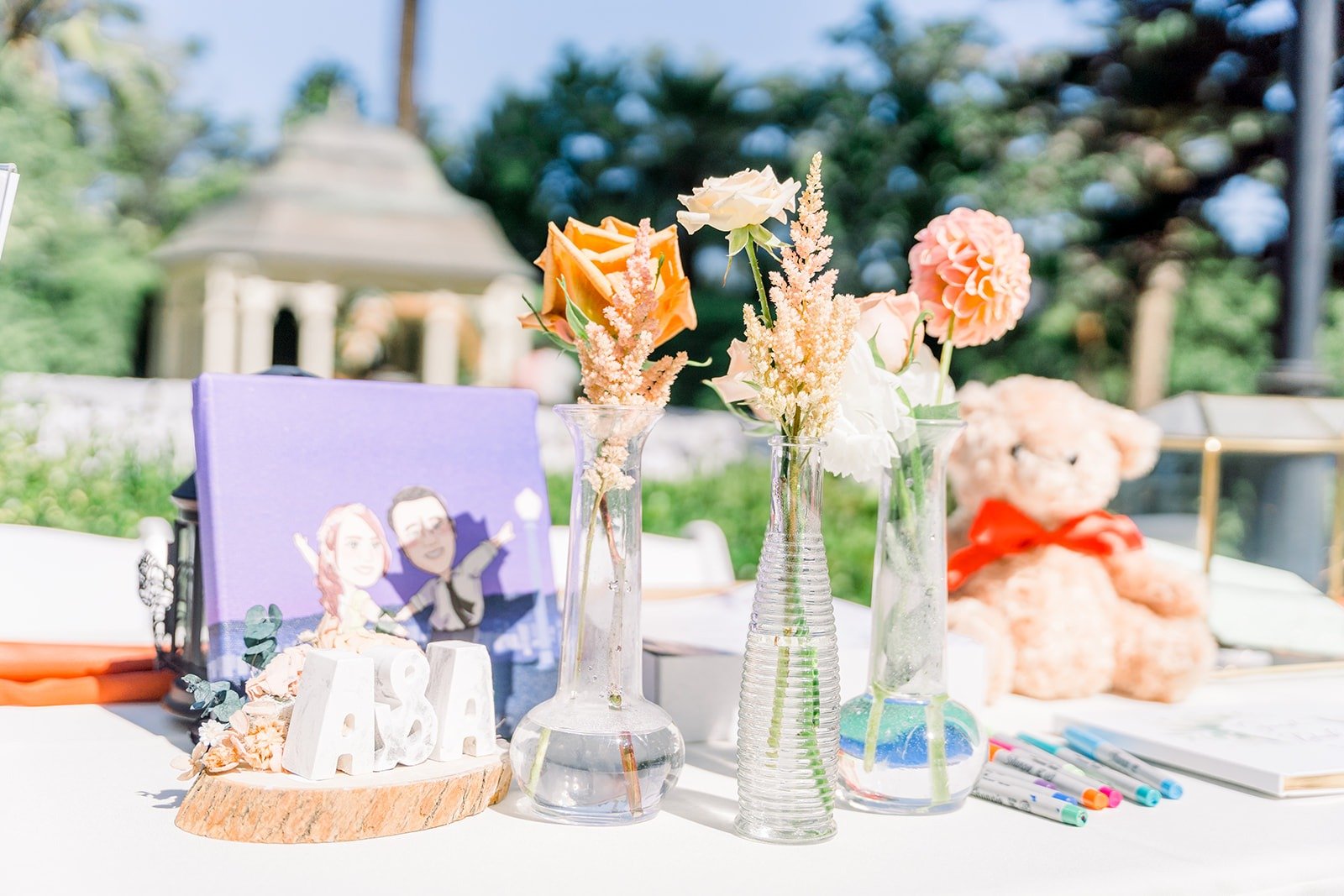 Ceremony welcome table with a vintage camera and florals
