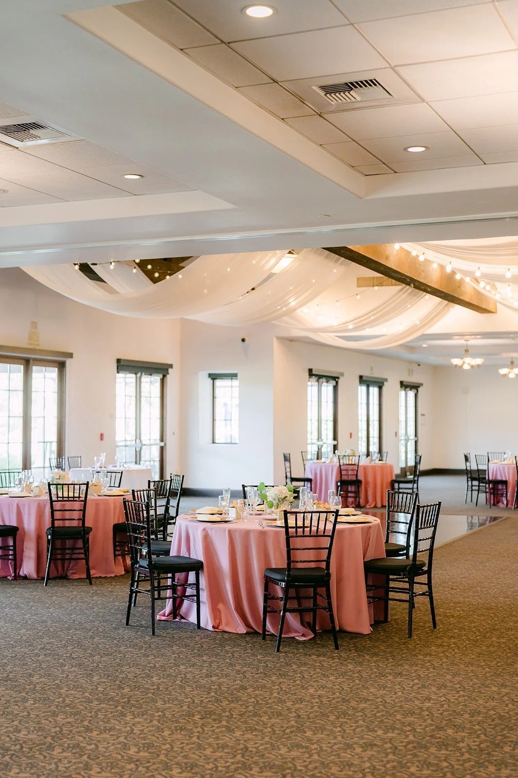 Reception tables with blush linens and dark chiavari chairs