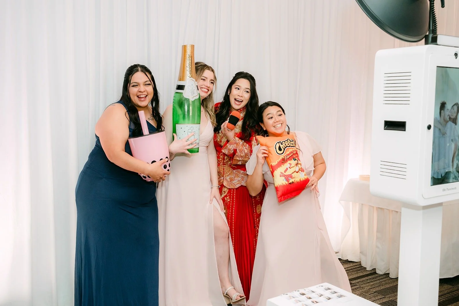 Amy with friends posing at the photobooth