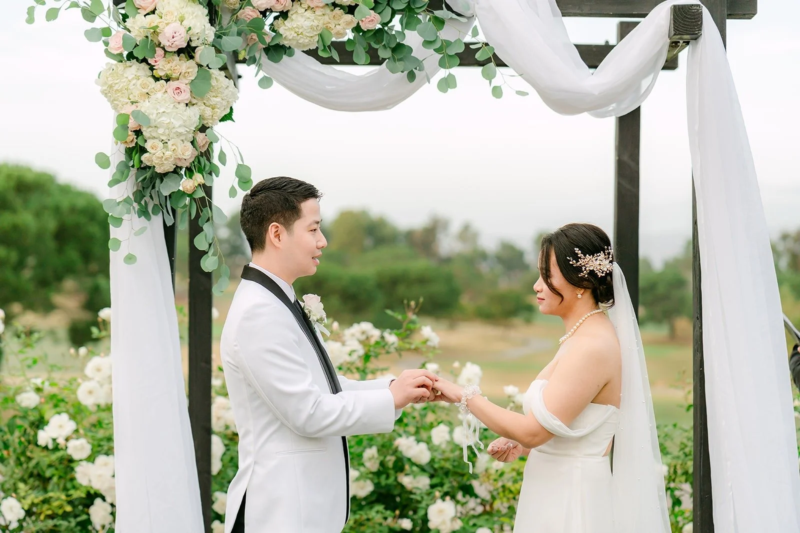 Ivy and Chungman exchanging rings at the arch