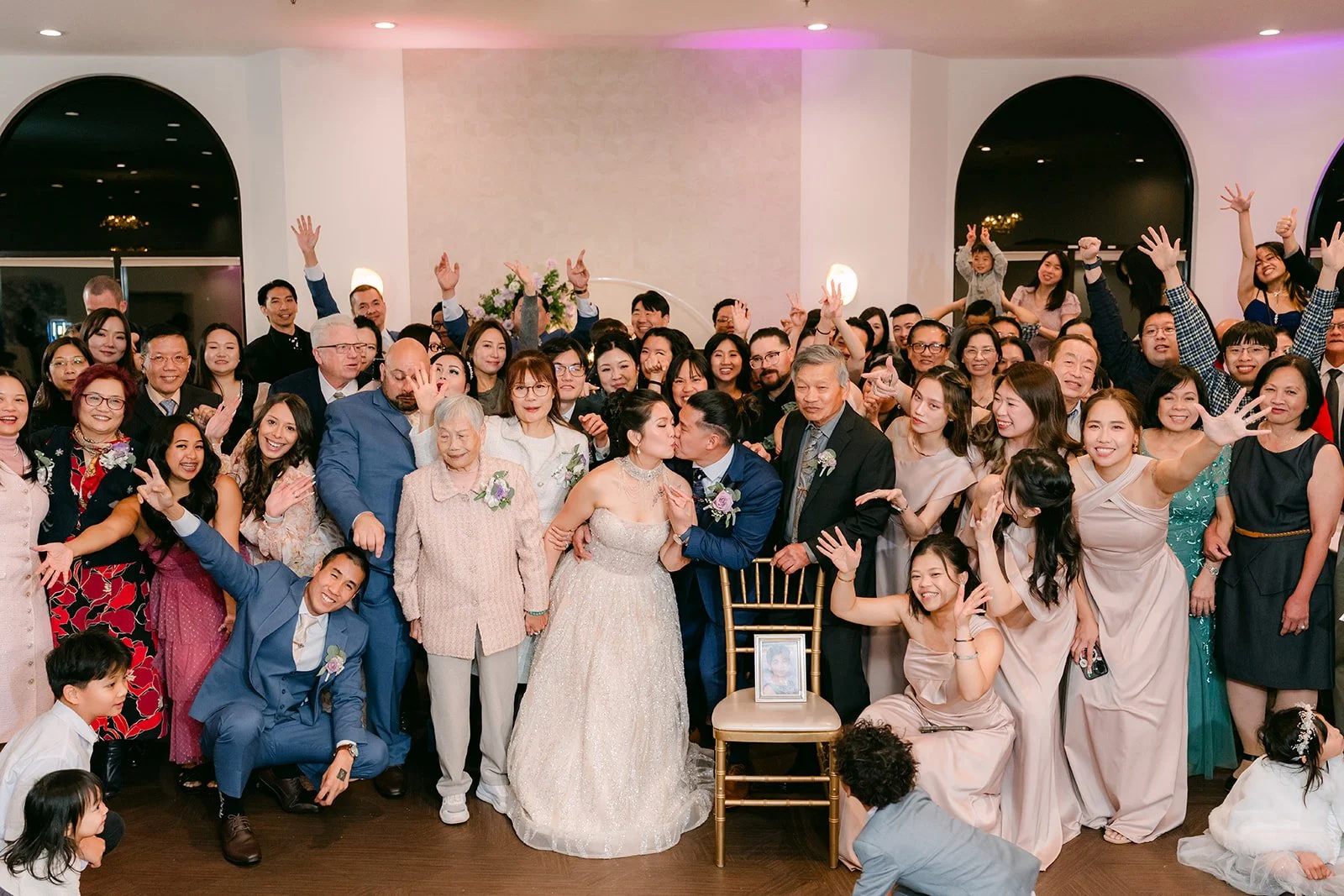 Guests crowding the dance floor for a group photo.