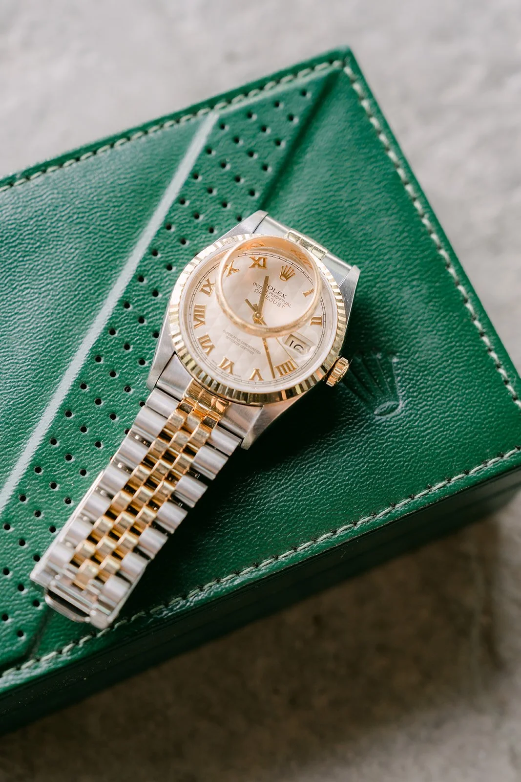 Elijah's watch resting on a green watch box.