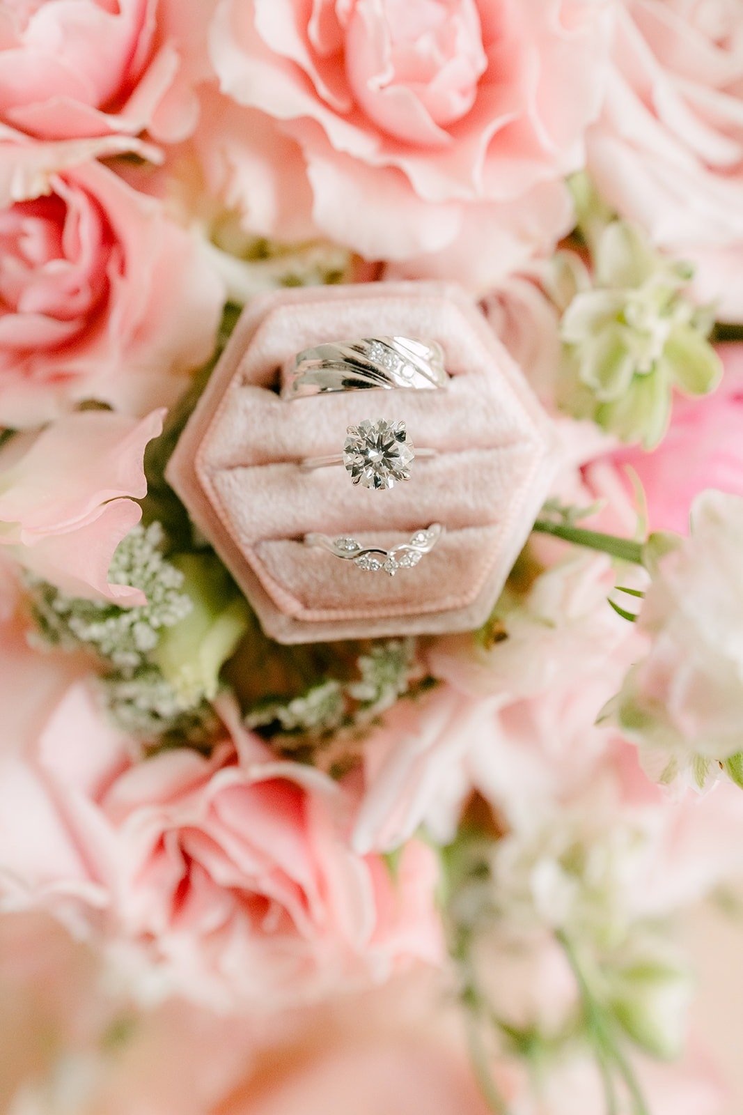 Engagement ring and bands nestled in the hexagon ring box