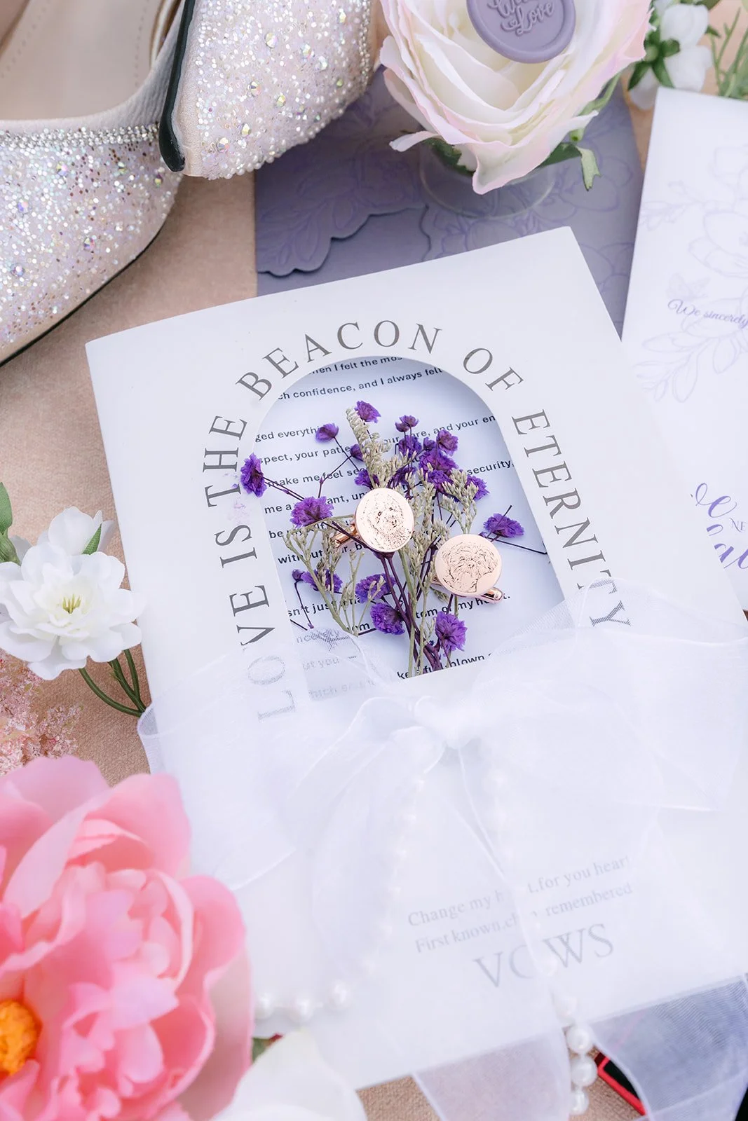 Kate and Michael's lilac invitation with a bouquet of lavender roses.