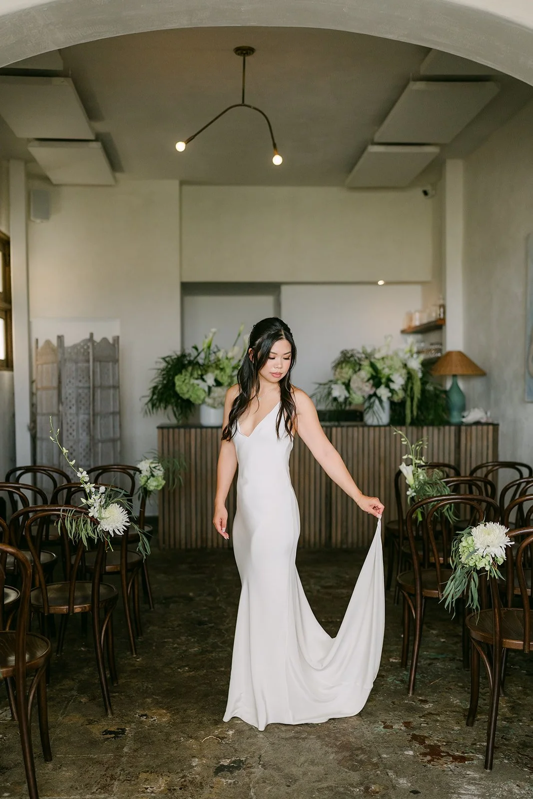 Justine in her slip gown under the arched room