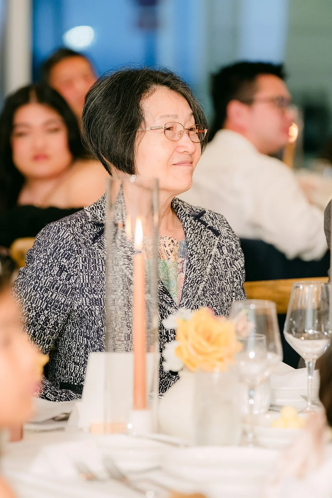 A guest laughing at her table during the speeches