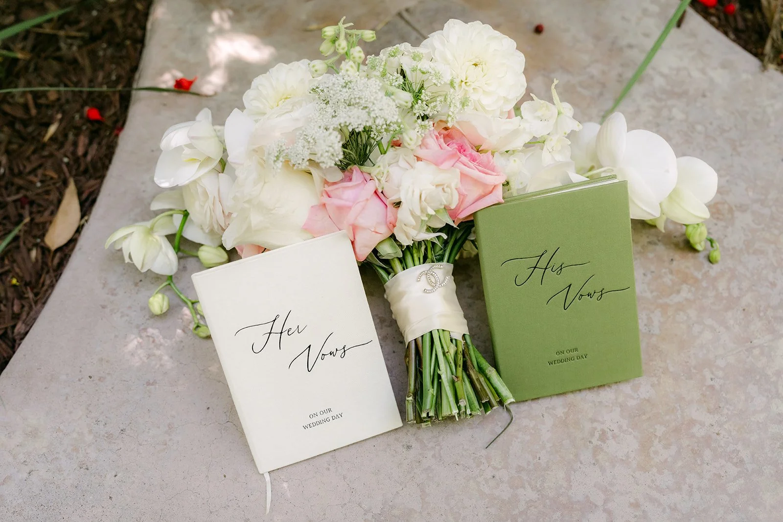 Nicole's bouquet with their His Vows and Her Vows books, photographed by One and Only Production.