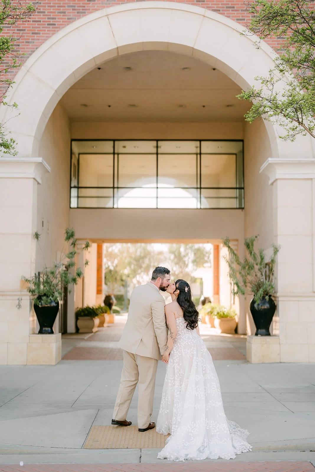Fernanda and Cody under a large stone archway.