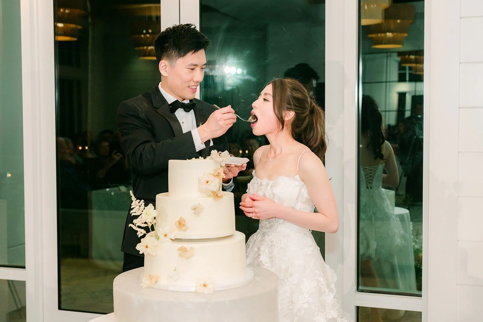 Angela and Eli sharing their first bite of cake