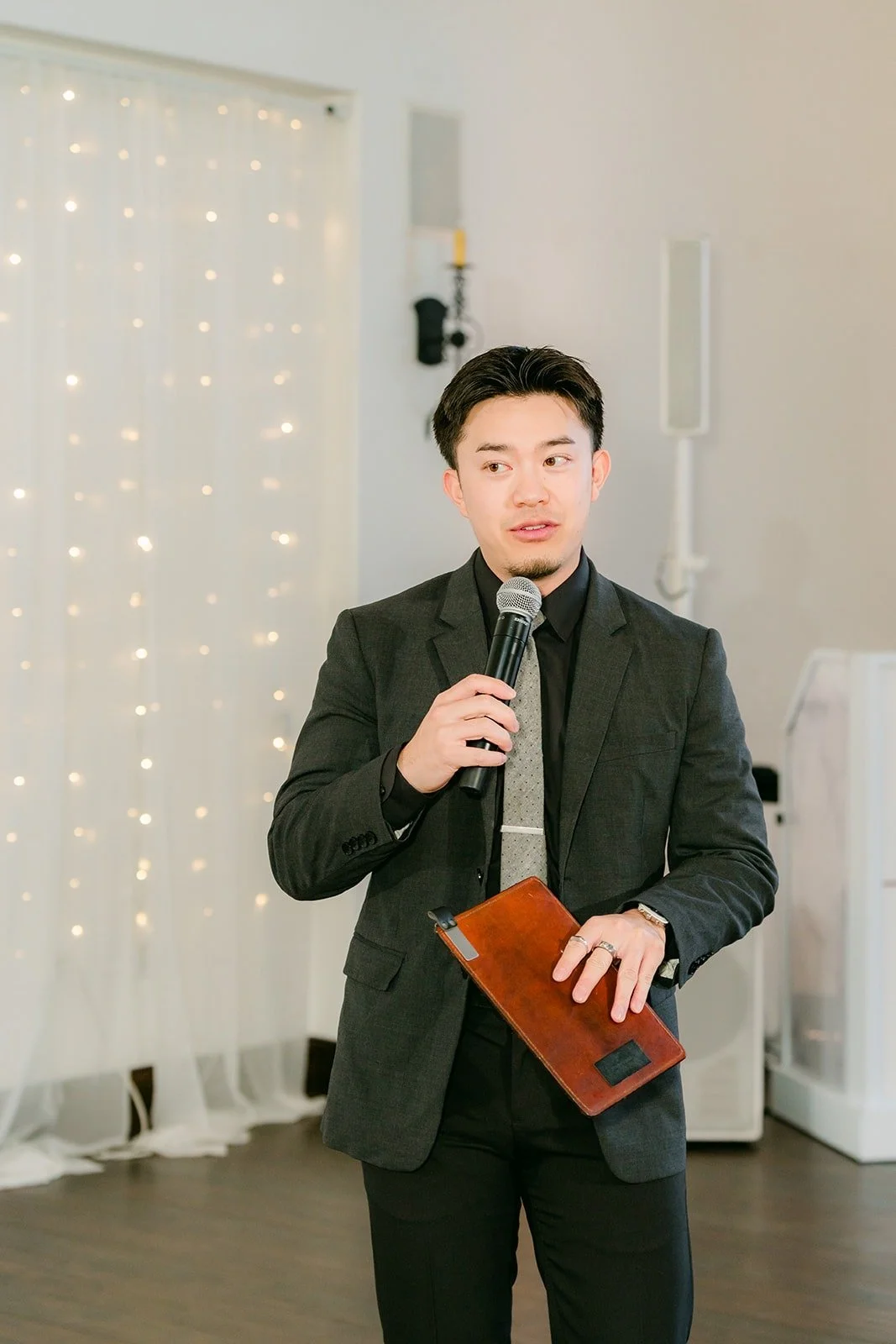 The emcee announcing the wedding party into the parlor