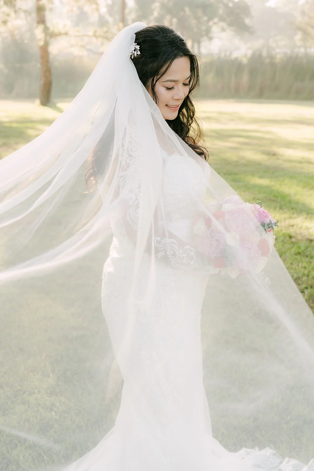 Amy turning with her cathedral veil flowing around her