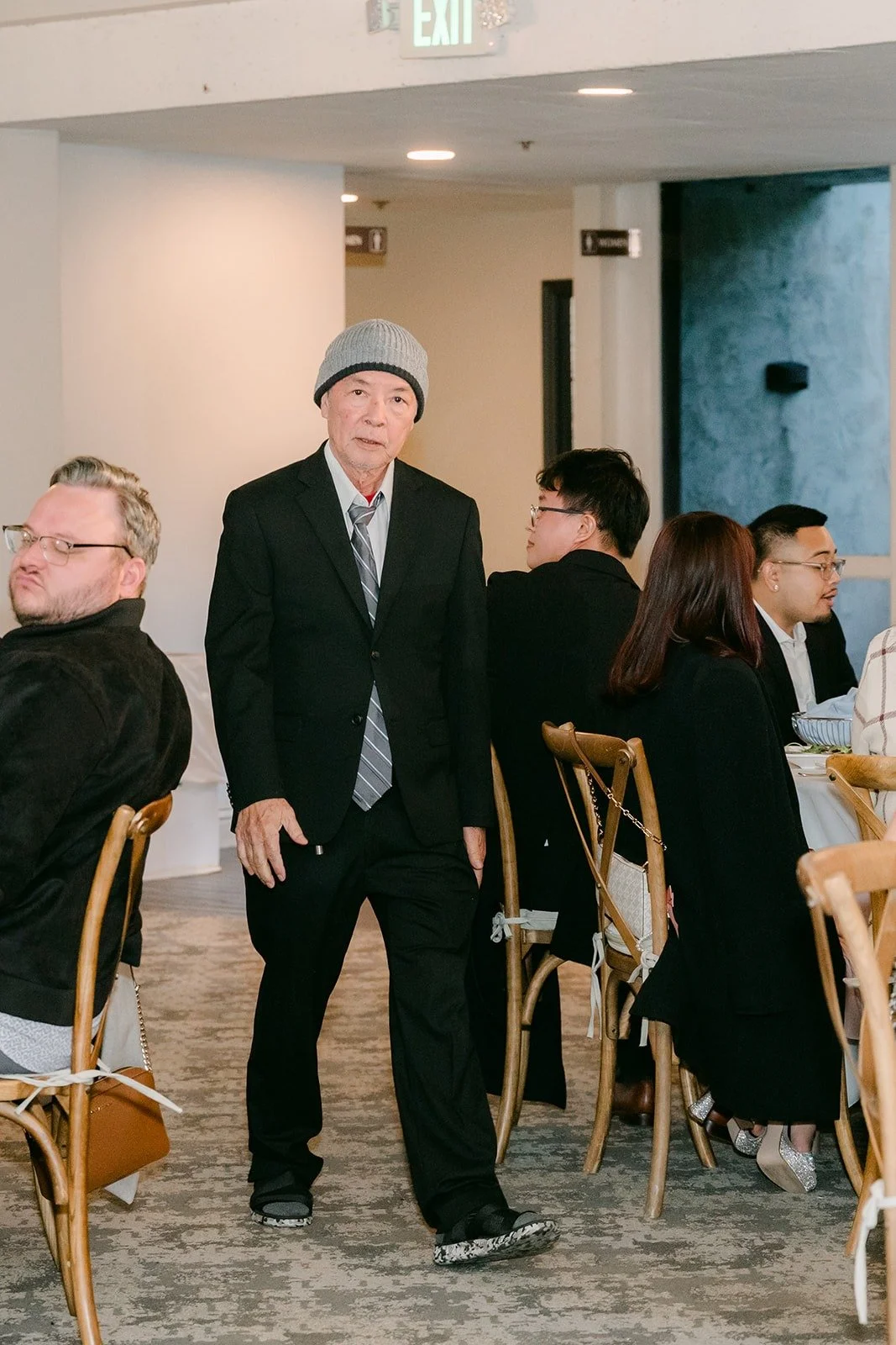 A family member walking into the ballroom during the grand entrance
