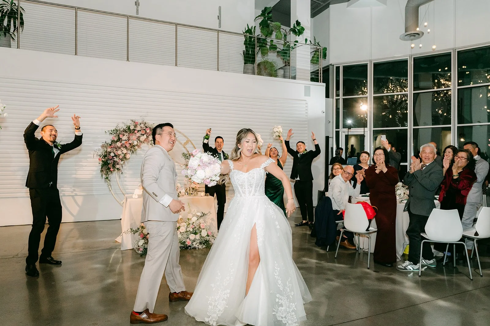 Bride and groom celebrating as they enter the reception