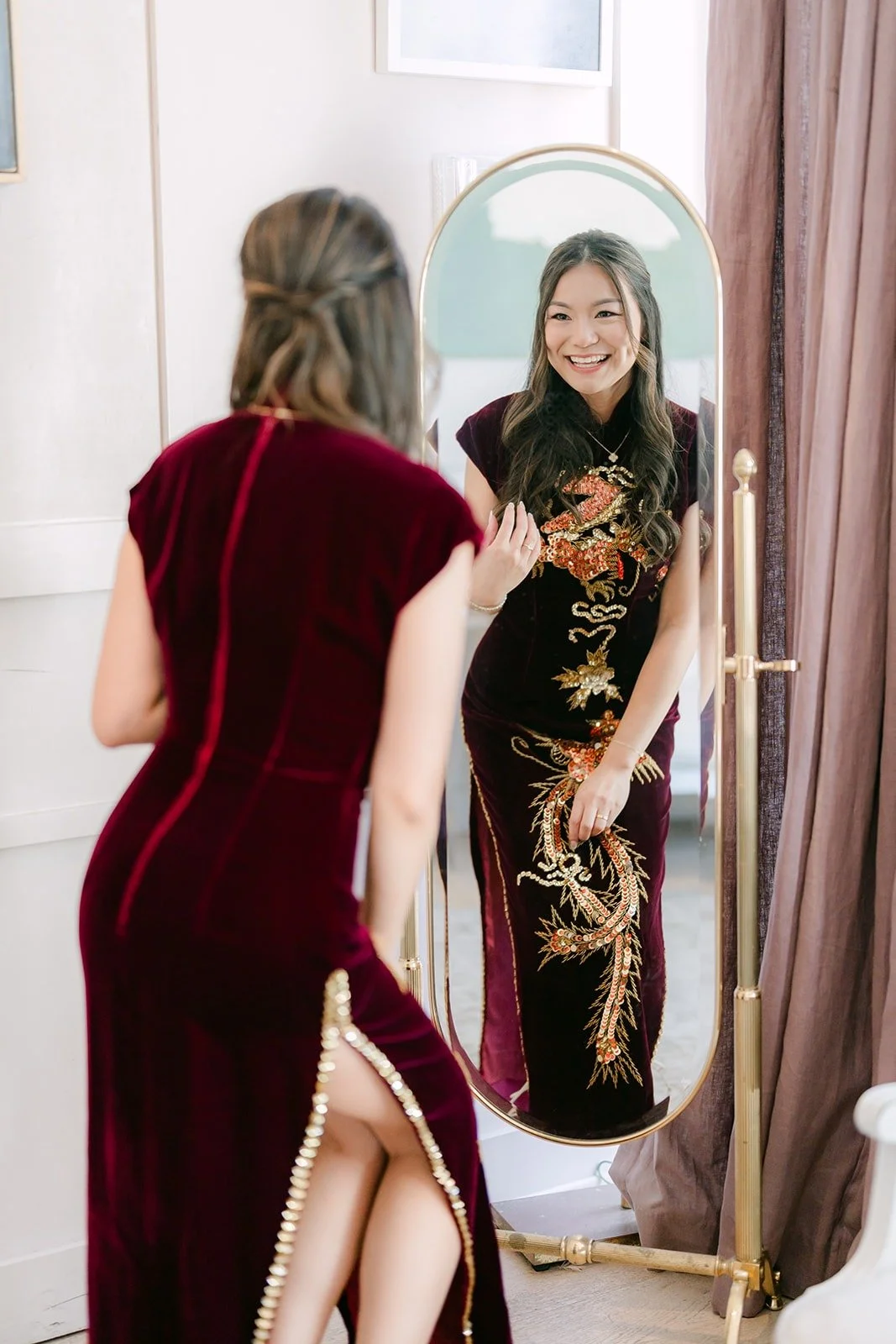 Jadee checking her qipao in the mirror