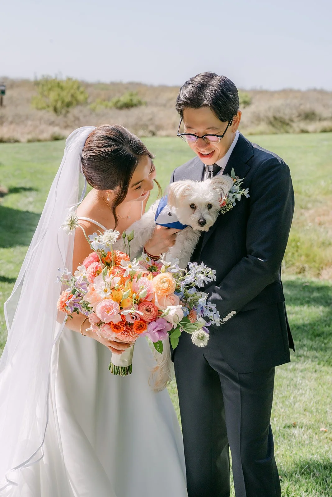 Leroy holding the dog while Saya beams