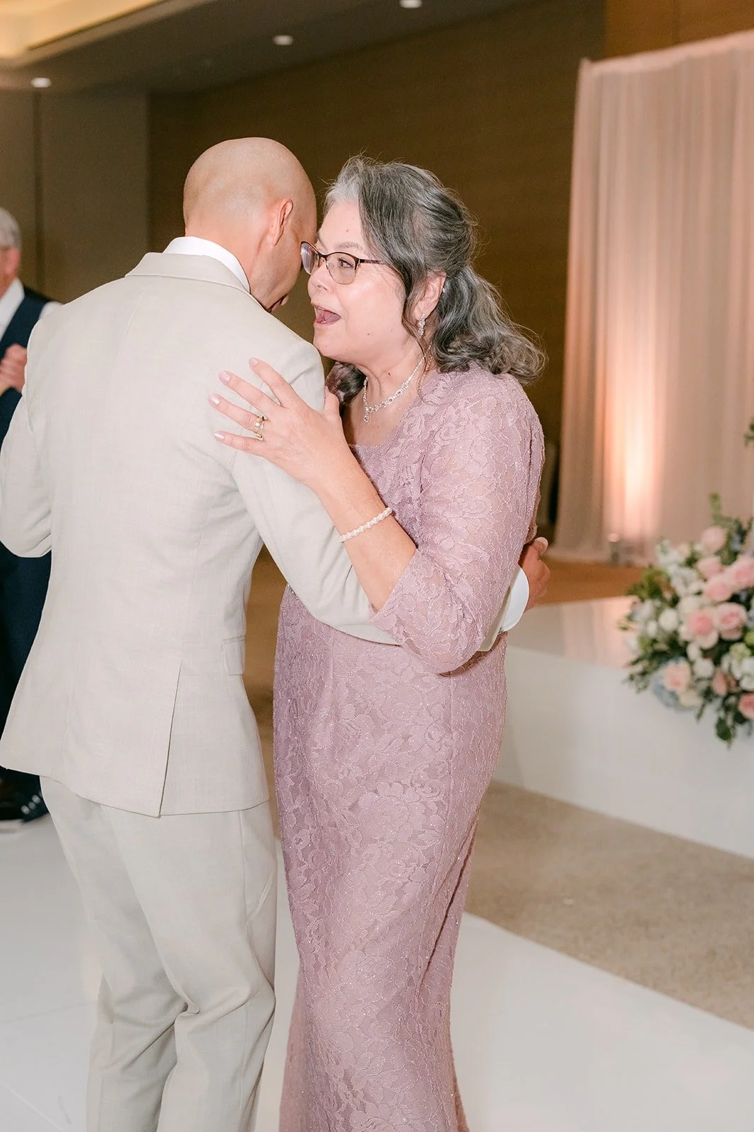 Daniel and a family member share a warm hug on the dance floor