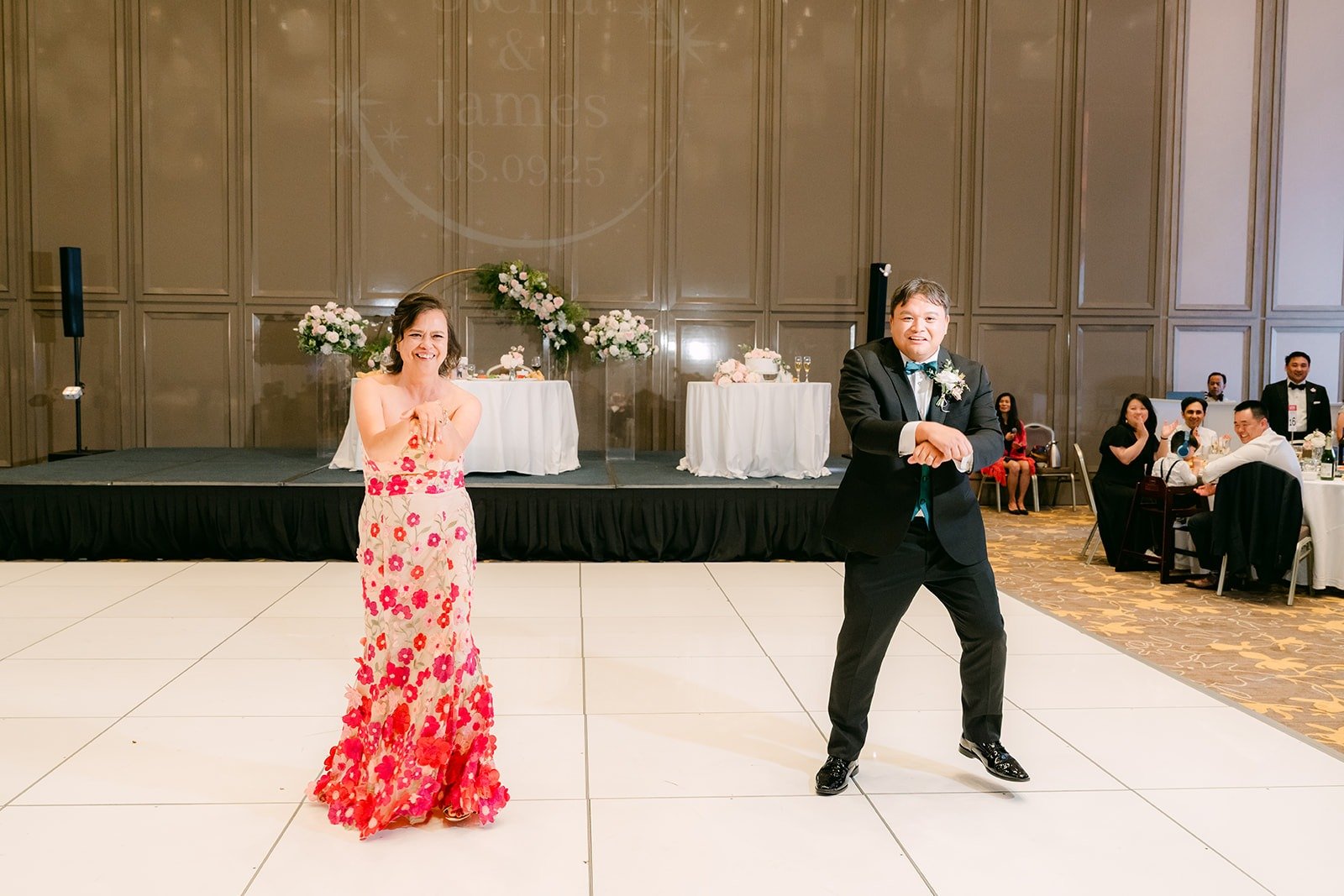 James and his dance partner laughing in the middle of the dance floor, photographed by One and Only Production