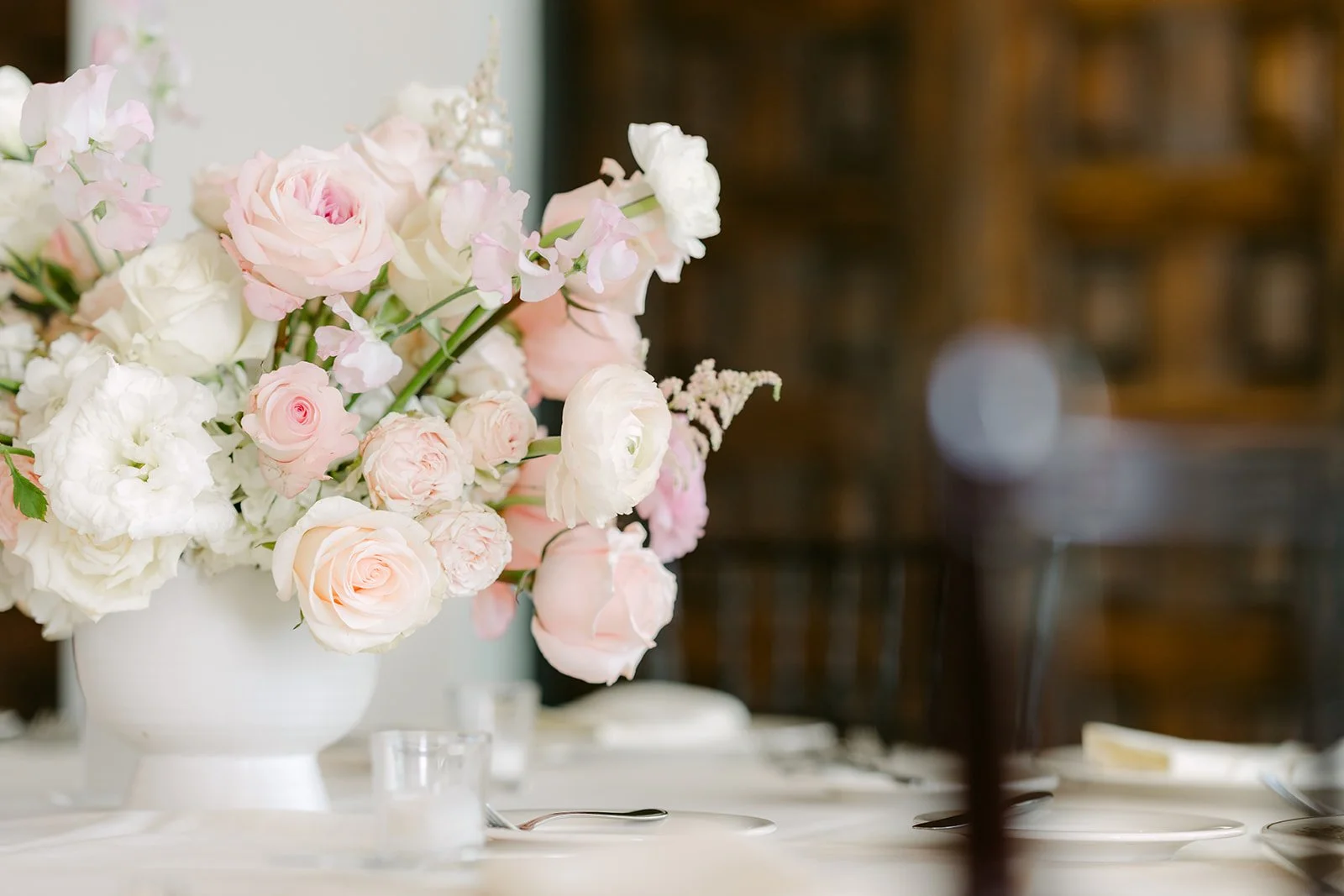 Blush and ivory rose centerpiece on a reception table