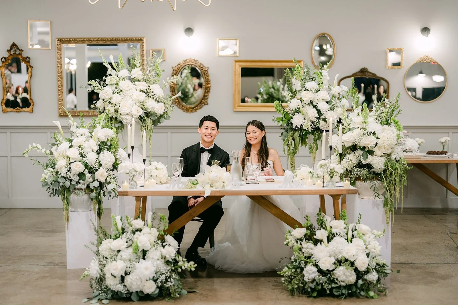 Jadee and Richard sitting at their sweetheart table