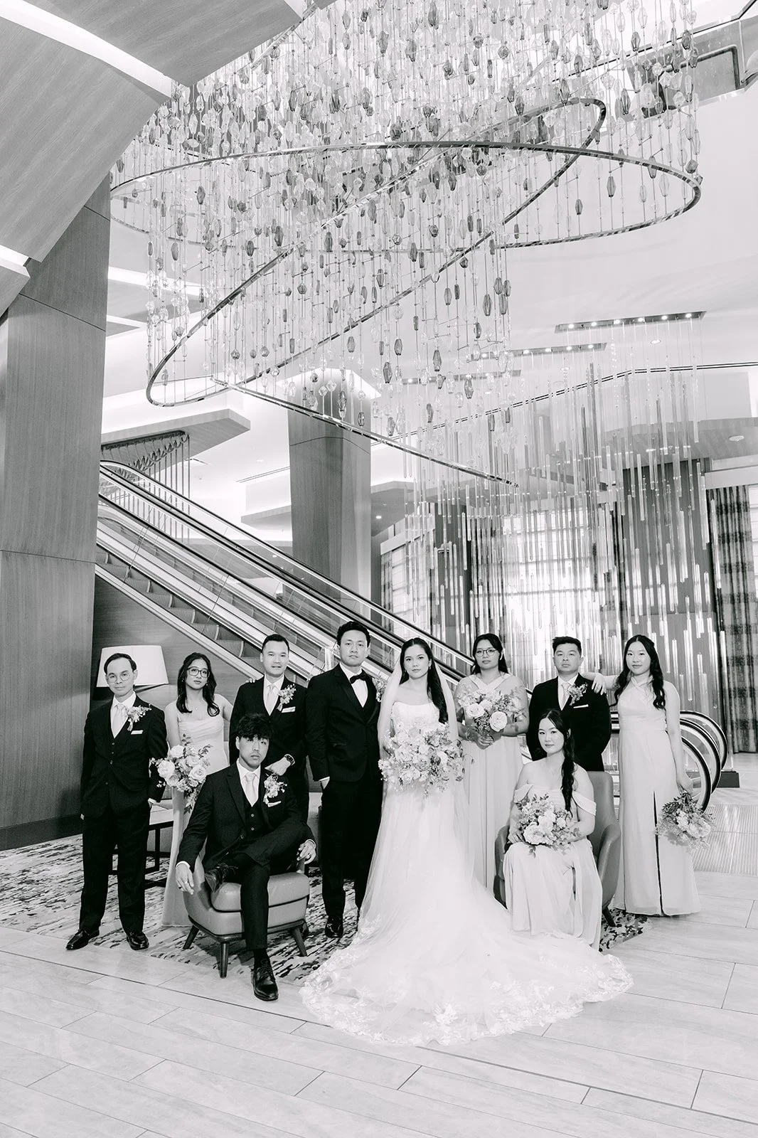 Black and white wedding party portrait in the hotel lobby