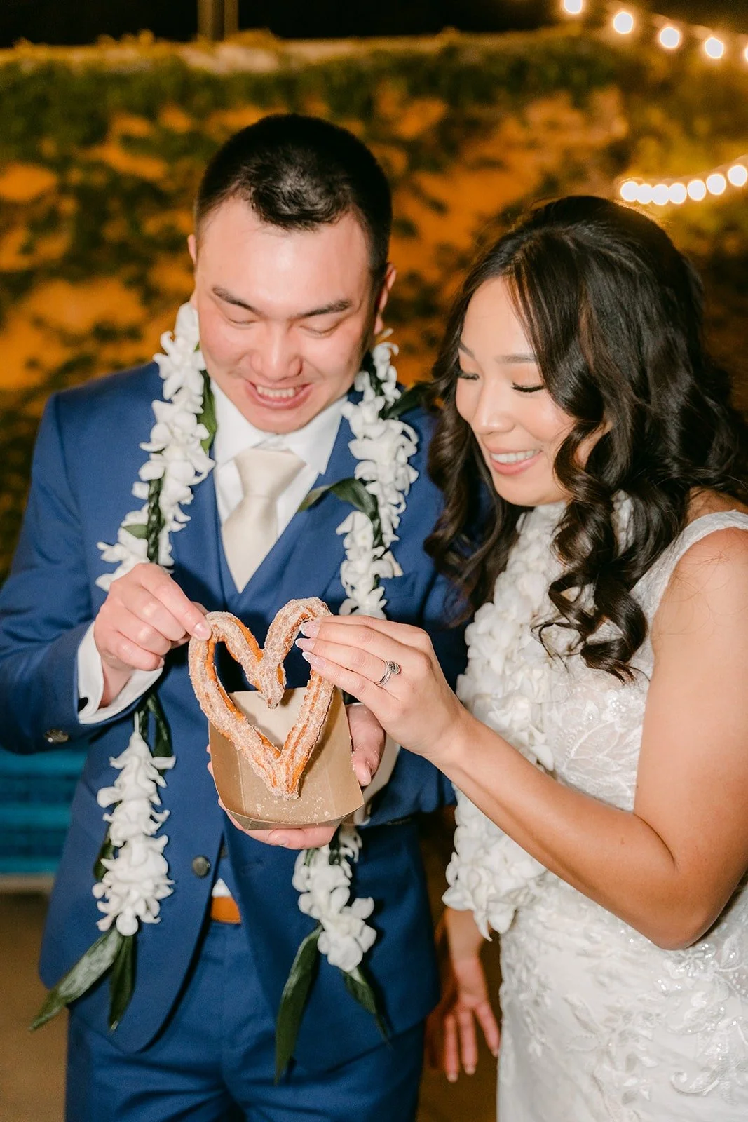 Kelli and Alex making a heart with their churros