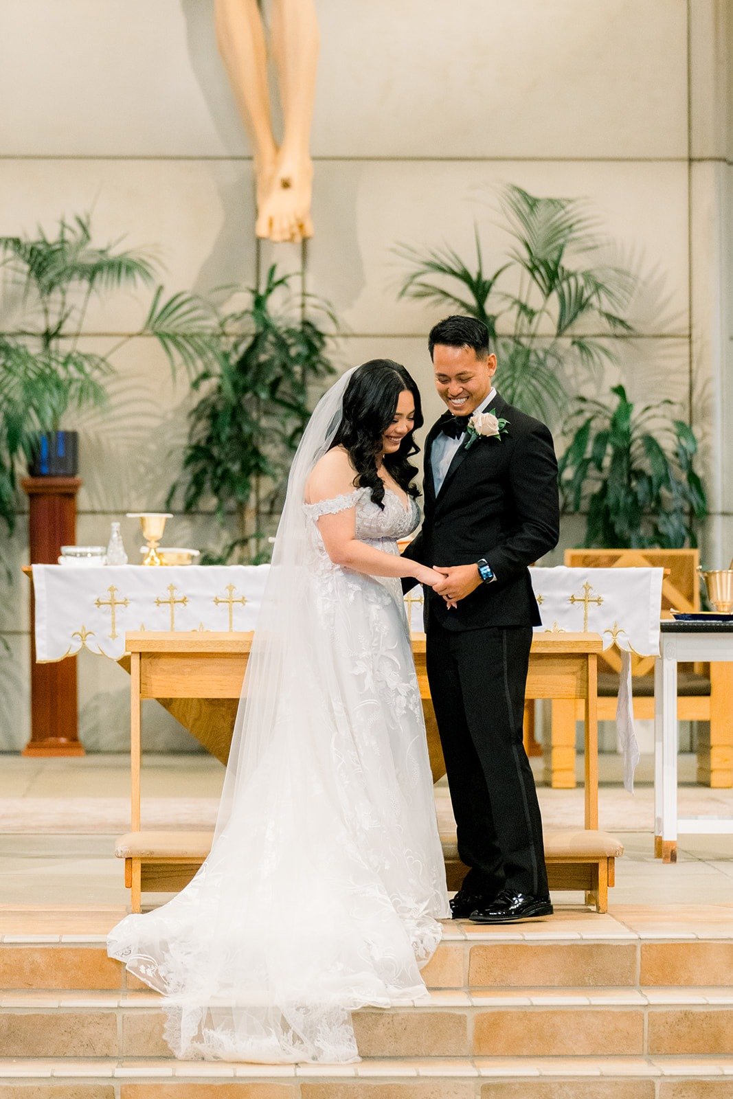 Francesca and Ralph laughing together at the altar